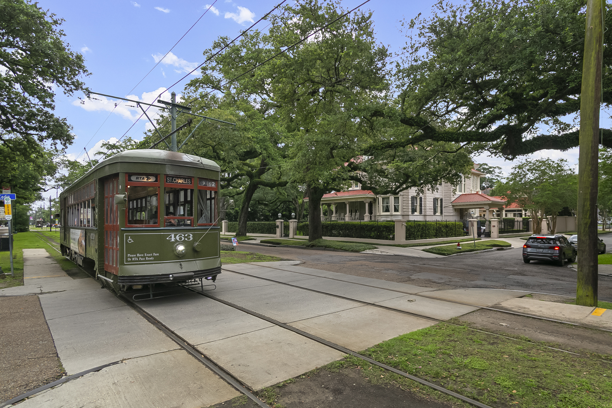 The St. Charles Avenue streetcar passing oak-lined Uptown New Orleans homes